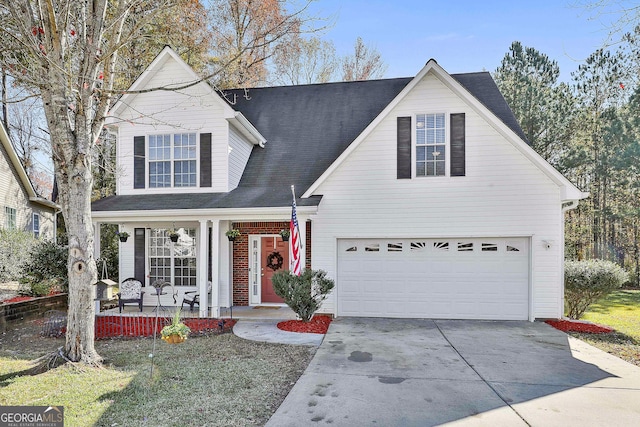 front of property featuring covered porch, a front yard, and a garage