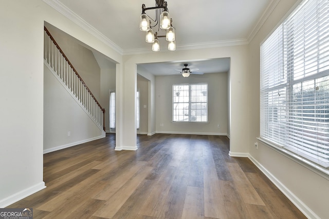 interior space with ceiling fan with notable chandelier, dark hardwood / wood-style flooring, and crown molding