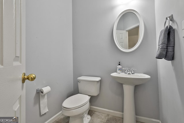 bathroom with sink, tile patterned flooring, and toilet