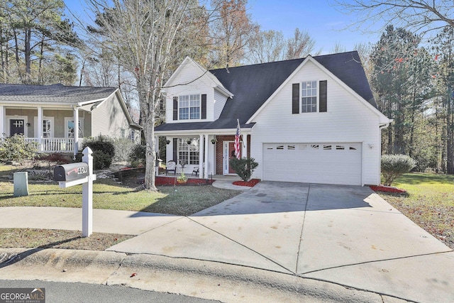 view of property featuring a front yard, a porch, and a garage