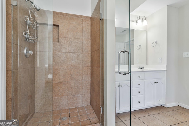 bathroom featuring tile patterned flooring, vanity, and a shower with shower door