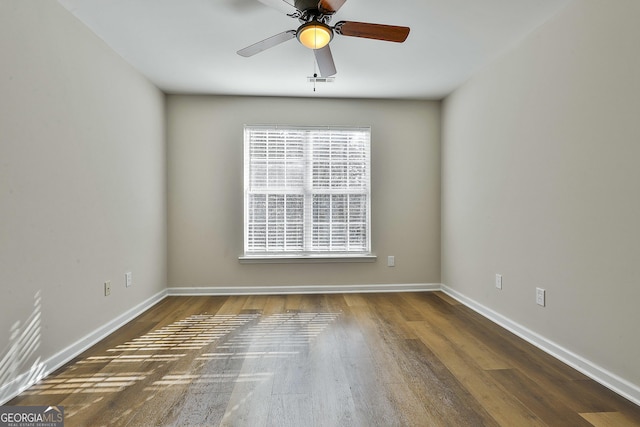 unfurnished room featuring dark hardwood / wood-style flooring and ceiling fan