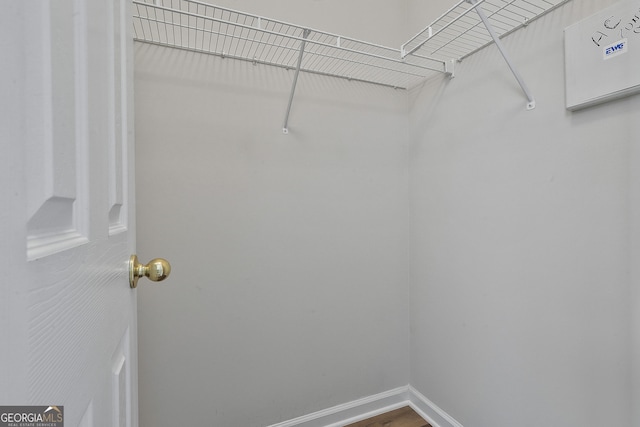 spacious closet featuring hardwood / wood-style flooring