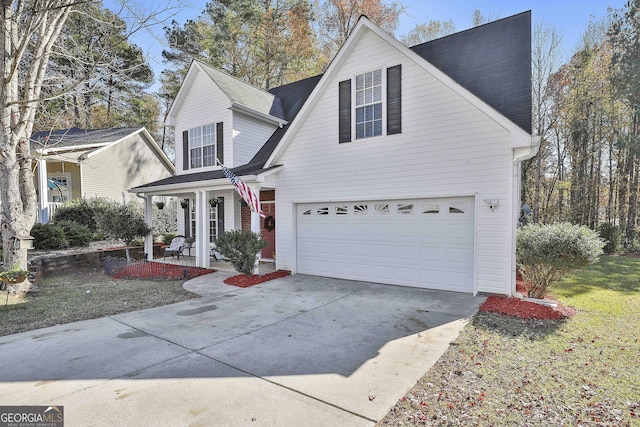 view of front property with covered porch, a garage, and a front lawn