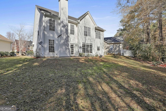 back of house featuring a yard