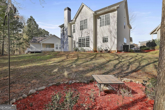 rear view of property with a lawn