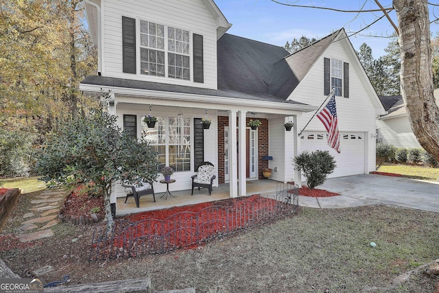 view of front property featuring covered porch and a garage