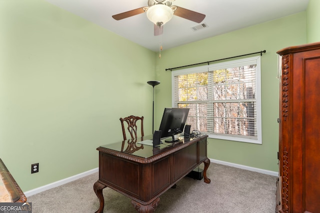 carpeted office space featuring ceiling fan