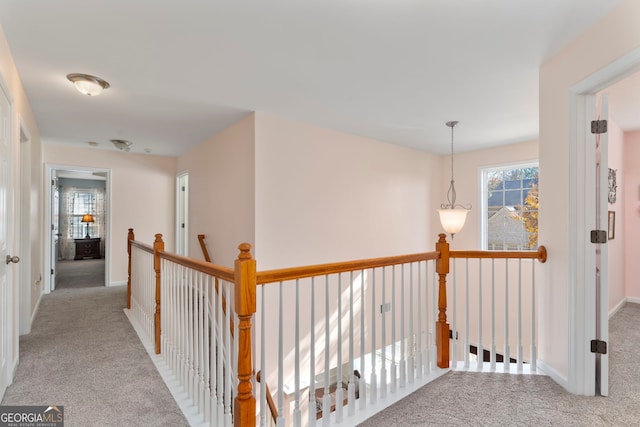 hall featuring light colored carpet