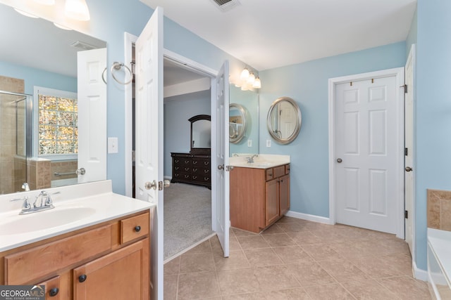 bathroom featuring plus walk in shower, vanity, and tile patterned floors