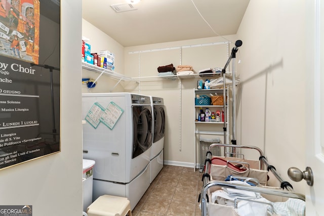 laundry room with washer and clothes dryer and light tile patterned flooring