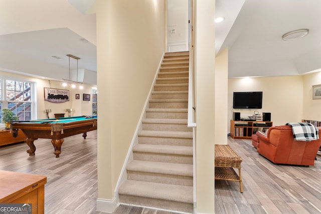 staircase with wood-type flooring, lofted ceiling, and pool table