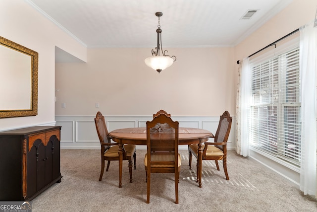 dining space featuring light carpet, a healthy amount of sunlight, and ornamental molding