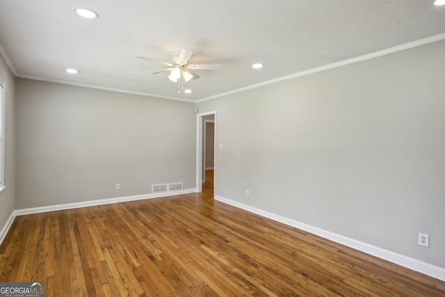 empty room with crown molding, ceiling fan, and wood-type flooring