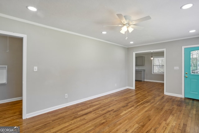 unfurnished living room with ceiling fan, hardwood / wood-style floors, and ornamental molding