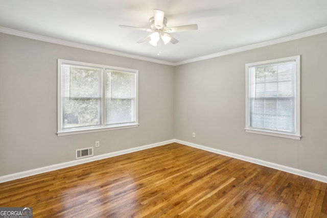 empty room with hardwood / wood-style floors, ceiling fan, and ornamental molding