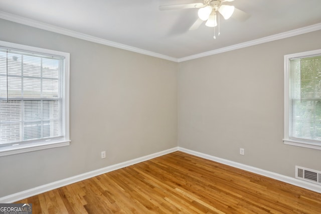 empty room featuring wood-type flooring, ceiling fan, and ornamental molding