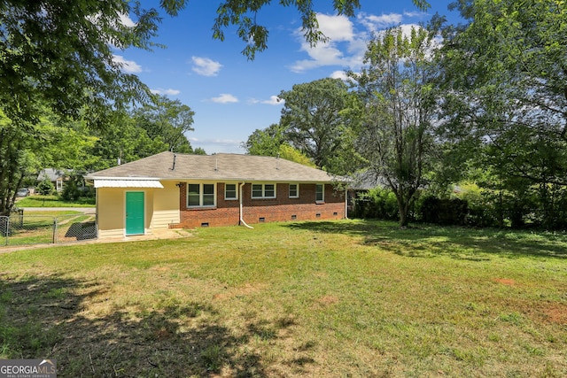 rear view of property with a lawn