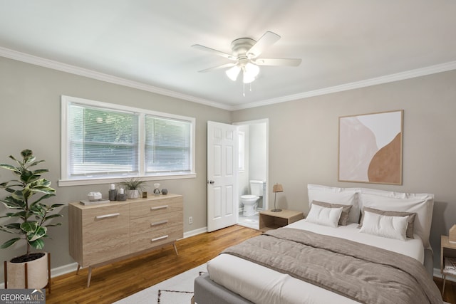 bedroom with ensuite bath, ceiling fan, dark hardwood / wood-style flooring, and ornamental molding