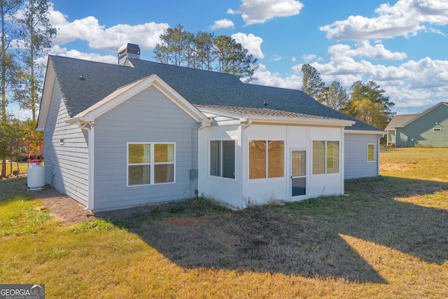 back of property with a lawn