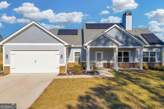 craftsman house with solar panels, a garage, and a front yard