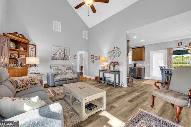 living room featuring ceiling fan, high vaulted ceiling, and light hardwood / wood-style flooring