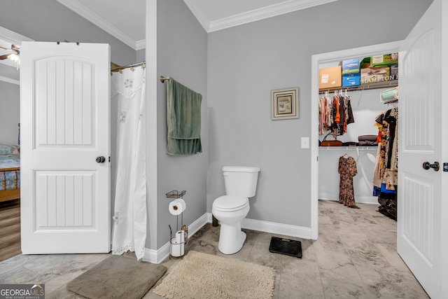 bathroom with crown molding, ceiling fan, and toilet