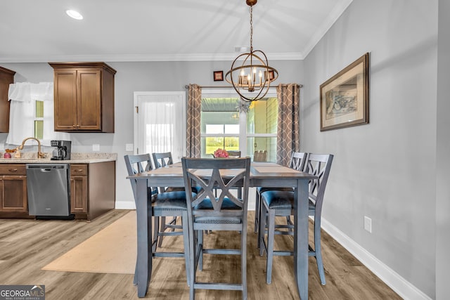 dining room with a wealth of natural light, a chandelier, and light wood-type flooring