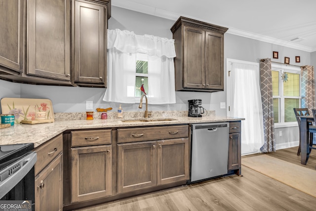 kitchen with crown molding, dishwasher, light hardwood / wood-style floors, and plenty of natural light