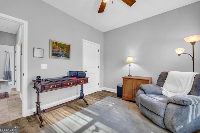 sitting room featuring hardwood / wood-style floors and ceiling fan