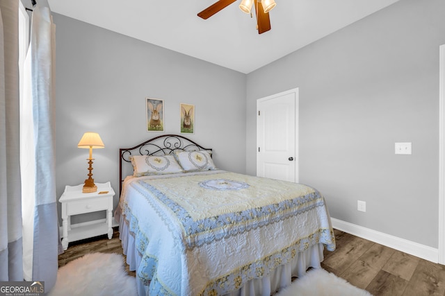 bedroom with ceiling fan and wood-type flooring