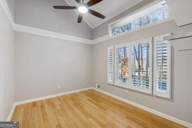 spare room with ceiling fan, hardwood / wood-style floors, lofted ceiling, and ornamental molding