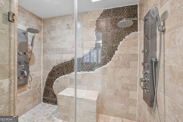 bathroom with a tile shower