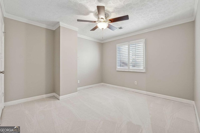 empty room with ceiling fan, crown molding, a textured ceiling, and light carpet