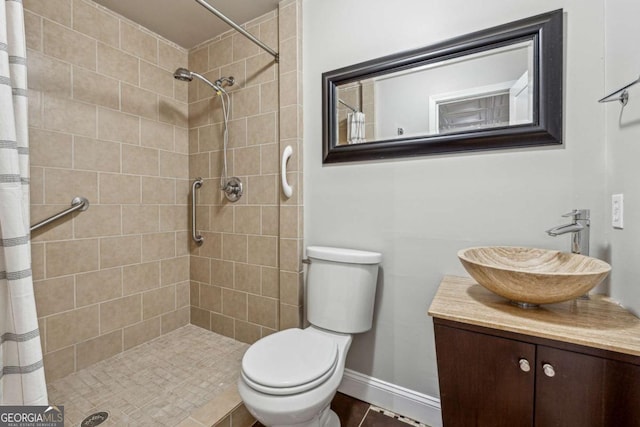 bathroom with tile patterned floors, vanity, curtained shower, and toilet