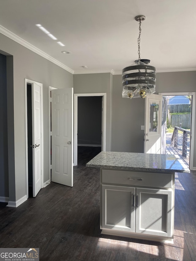 kitchen with pendant lighting, dark hardwood / wood-style flooring, crown molding, and a notable chandelier