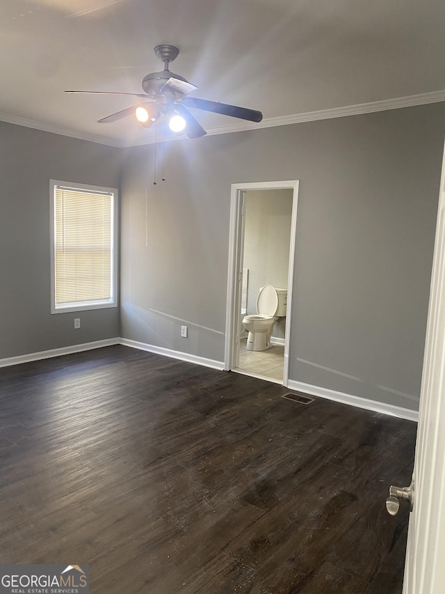 spare room featuring dark hardwood / wood-style floors, ceiling fan, and ornamental molding