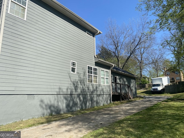 view of side of property with a yard