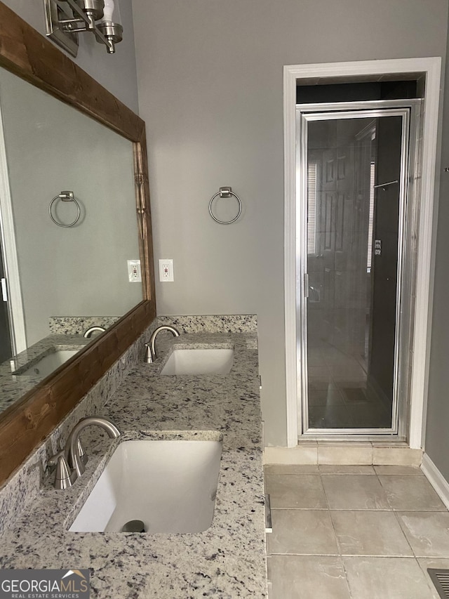 bathroom featuring tile patterned flooring and vanity