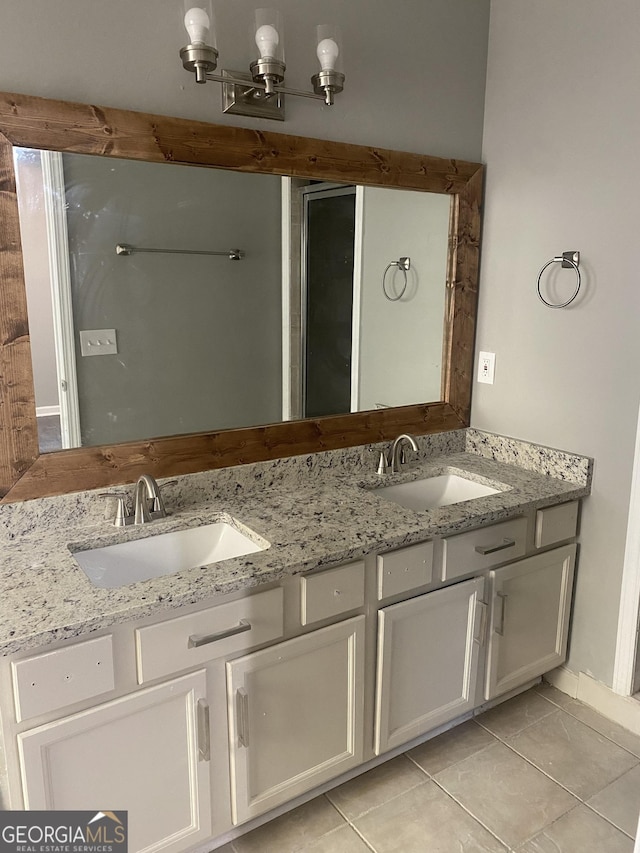 bathroom with tile patterned floors and vanity