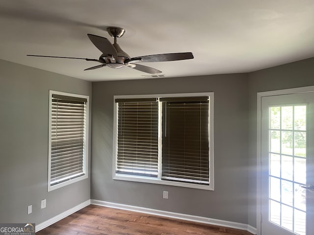 spare room with ceiling fan and wood-type flooring