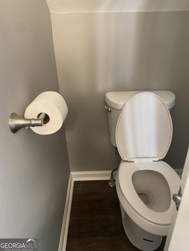 bathroom with hardwood / wood-style floors and toilet