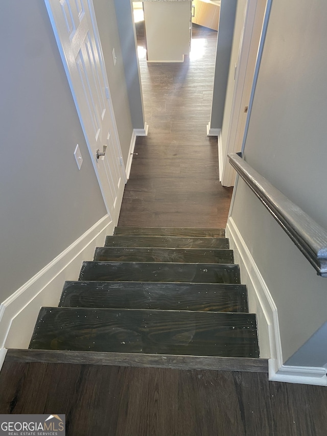 stairs featuring hardwood / wood-style floors