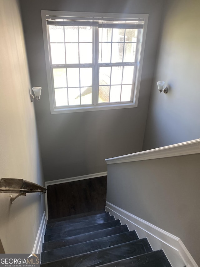 stairs with wood-type flooring