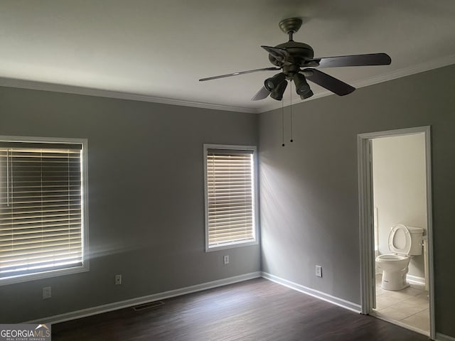 unfurnished room with ceiling fan, crown molding, and dark wood-type flooring