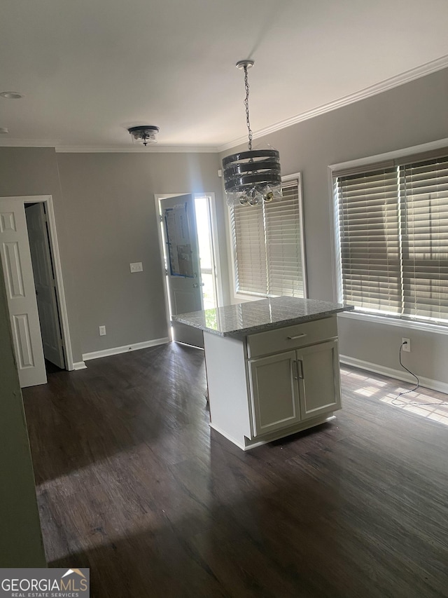 kitchen featuring dark hardwood / wood-style flooring, light stone countertops, hanging light fixtures, and an inviting chandelier