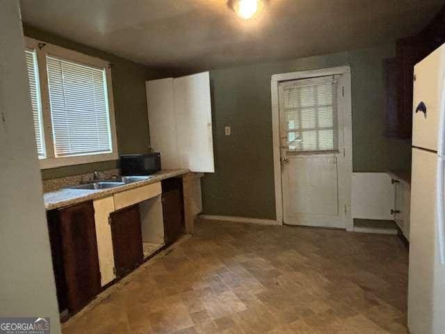 kitchen featuring white fridge and sink