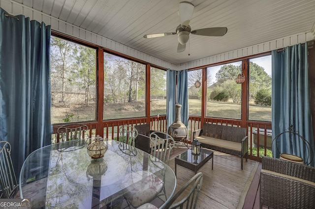 sunroom / solarium featuring ceiling fan and plenty of natural light