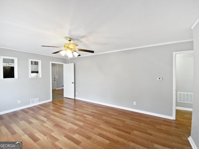 unfurnished room featuring light hardwood / wood-style floors, ceiling fan, and ornamental molding