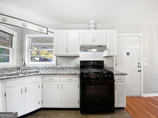 kitchen featuring white cabinetry, a wealth of natural light, dark wood-type flooring, and black gas range oven